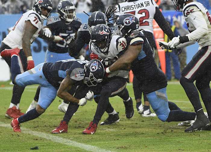 Tennessee Titans free safety Kevin Byard (31) and Tennessee Titans defensive tackle Jeffery Simmons (98) tackle Houston Texans running back David Johnson (31) just after he crosses out of the end zone during the second half at Nissan Stadium.